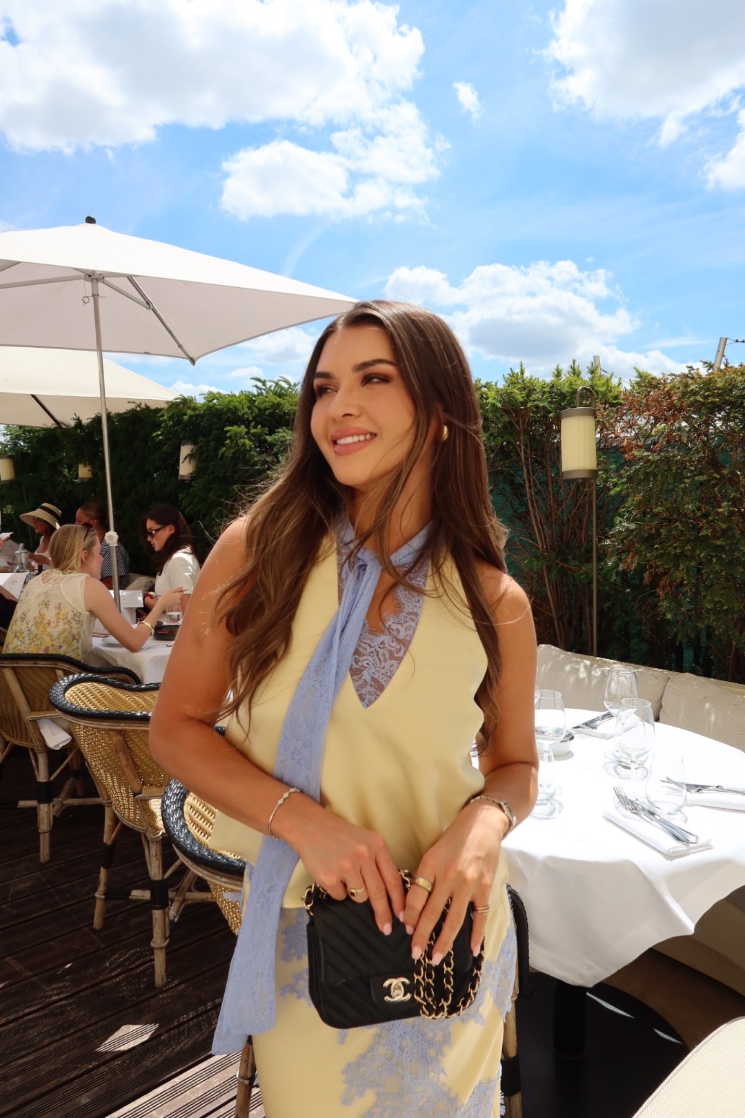 Jess O'Neill smiling at an outdoor restaurant