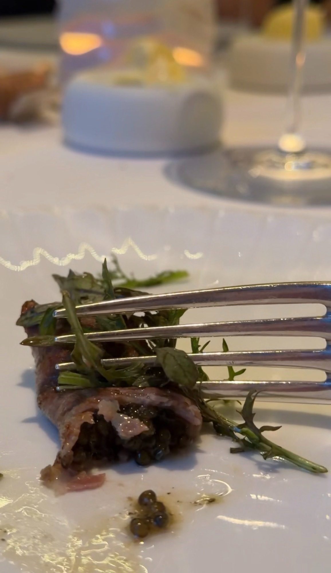 A rolled piece of meat cut open to show a dark filling at Restaurant Alliance