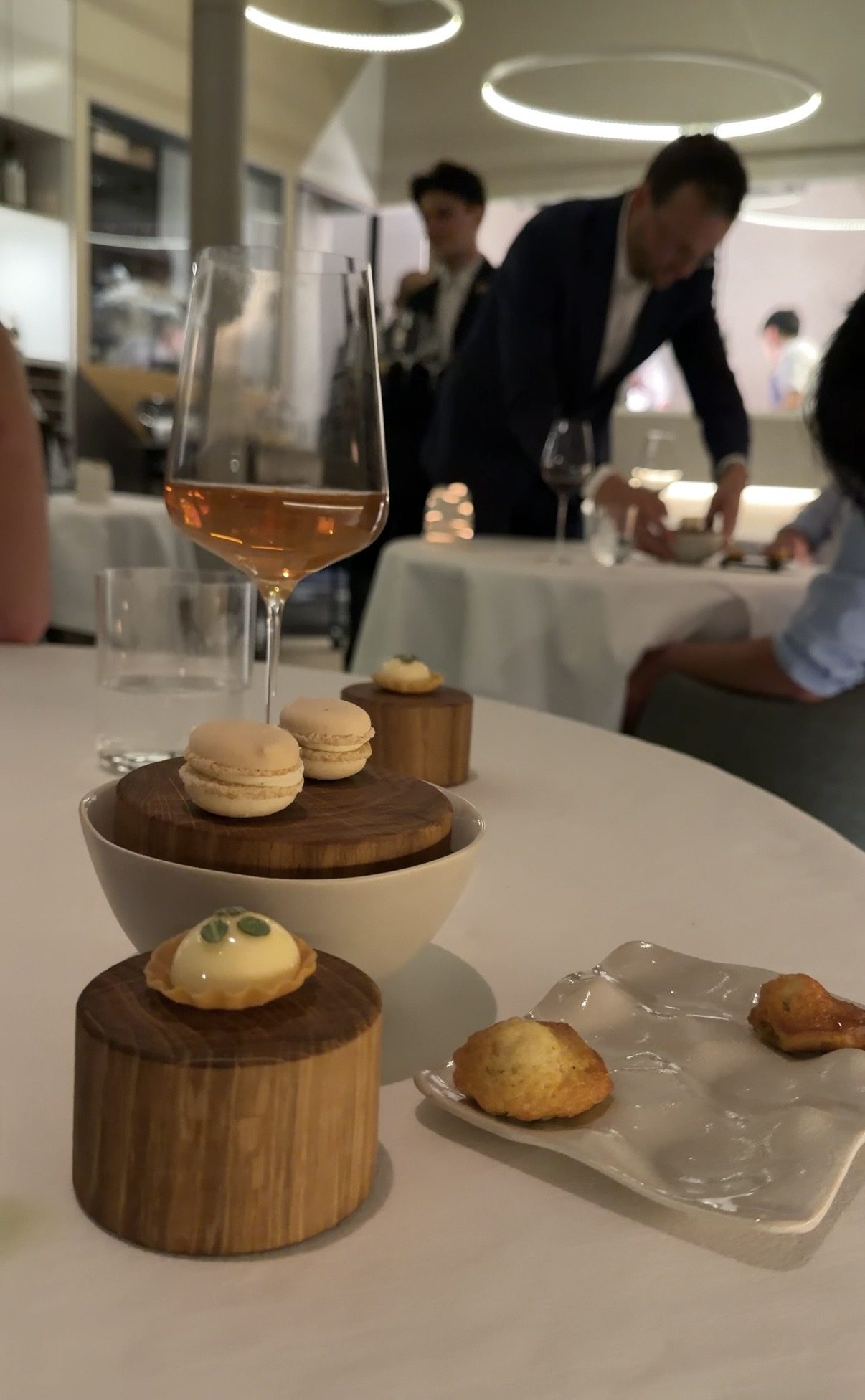 Macarons, a small tart, and petit fours with a glass of rosé at Restaurant Alliance in Paris