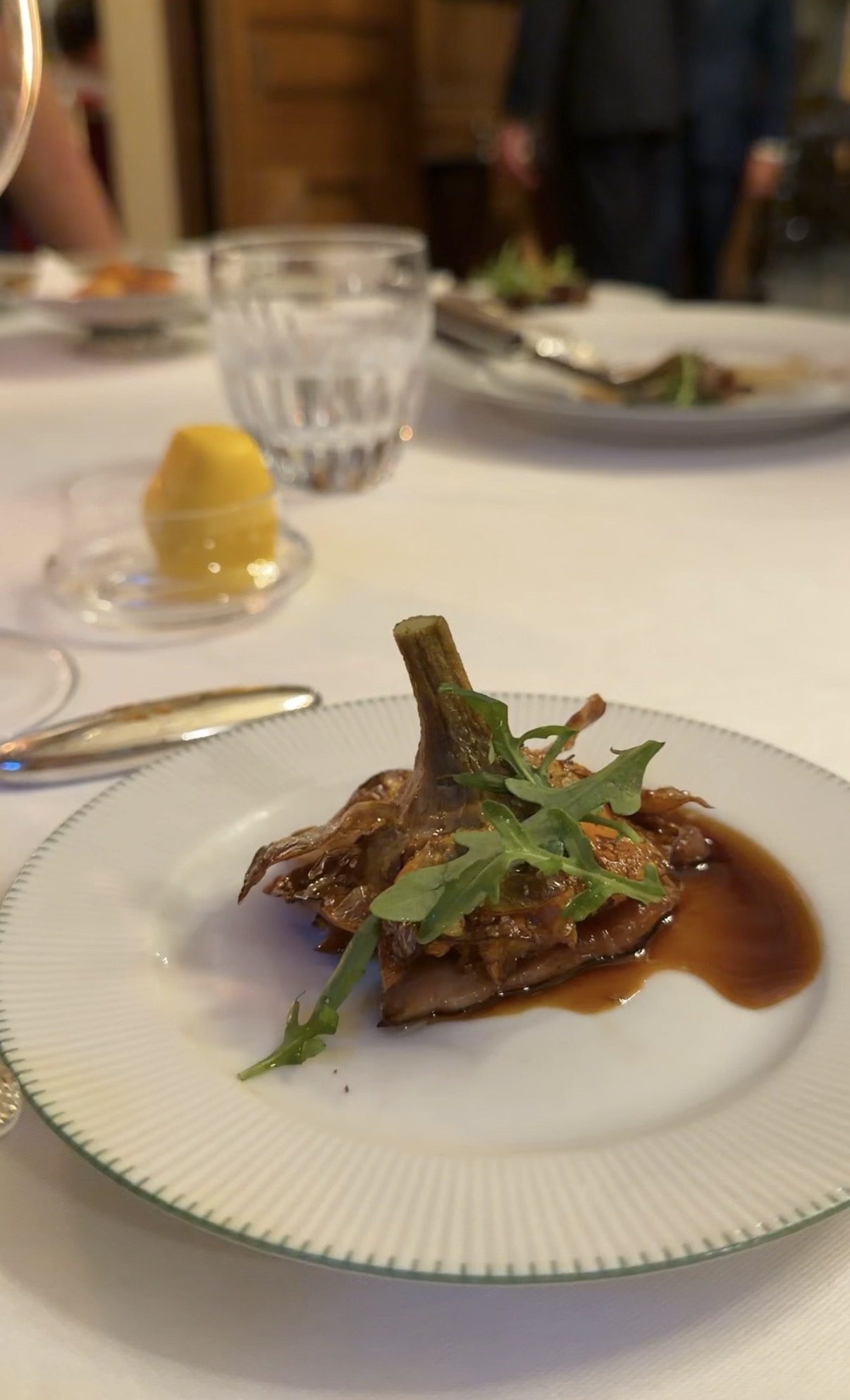 A braised artichoke with herbs and a dark sauce at Le Clarence