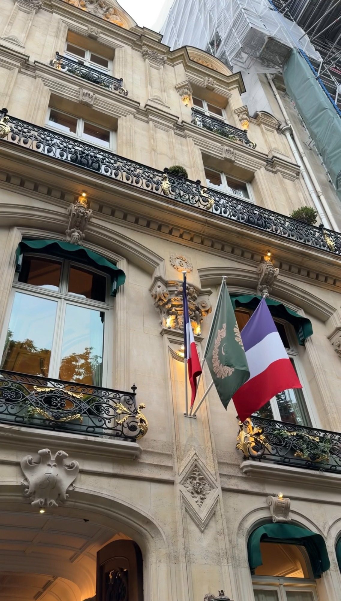 The stone facade of Le Clarence on avenue Franklin D. Roosevelt in Paris, with flags above the entrance