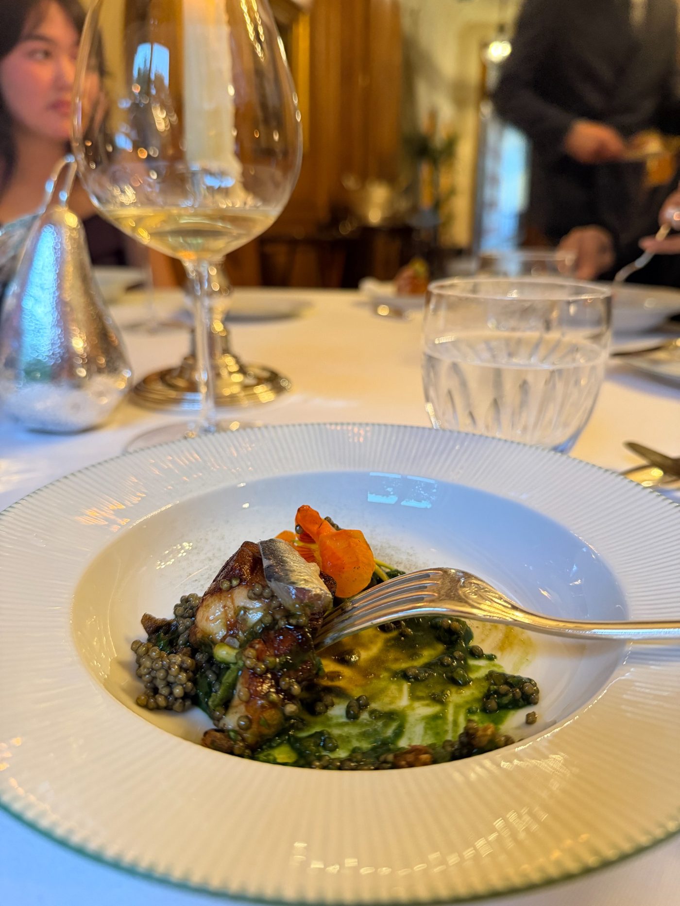 Lentils with fish, carrots, and a green sauce at Le Clarence Paris