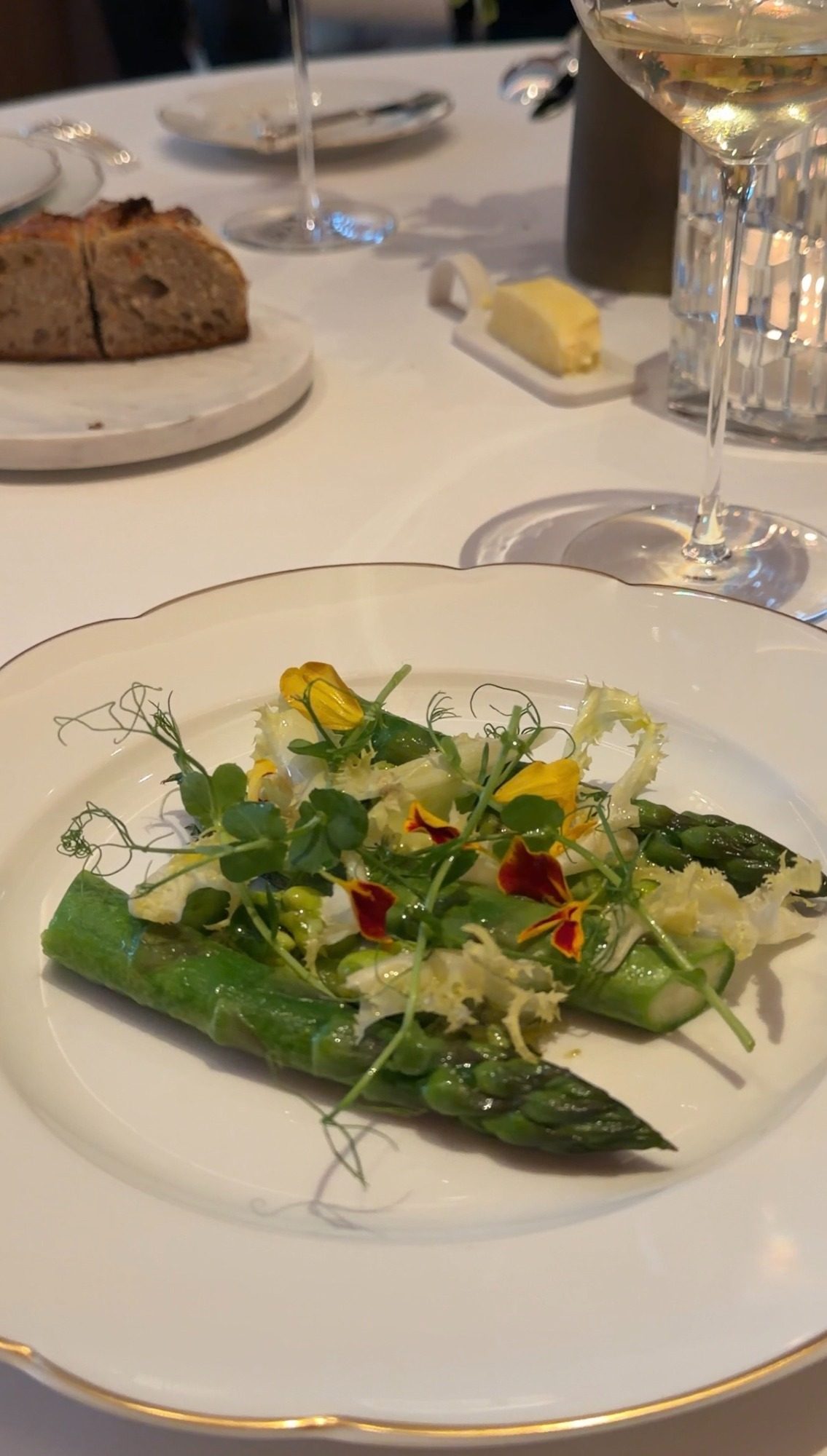 Green asparagus with herbs and edible flowers at Le Taillevent Paris