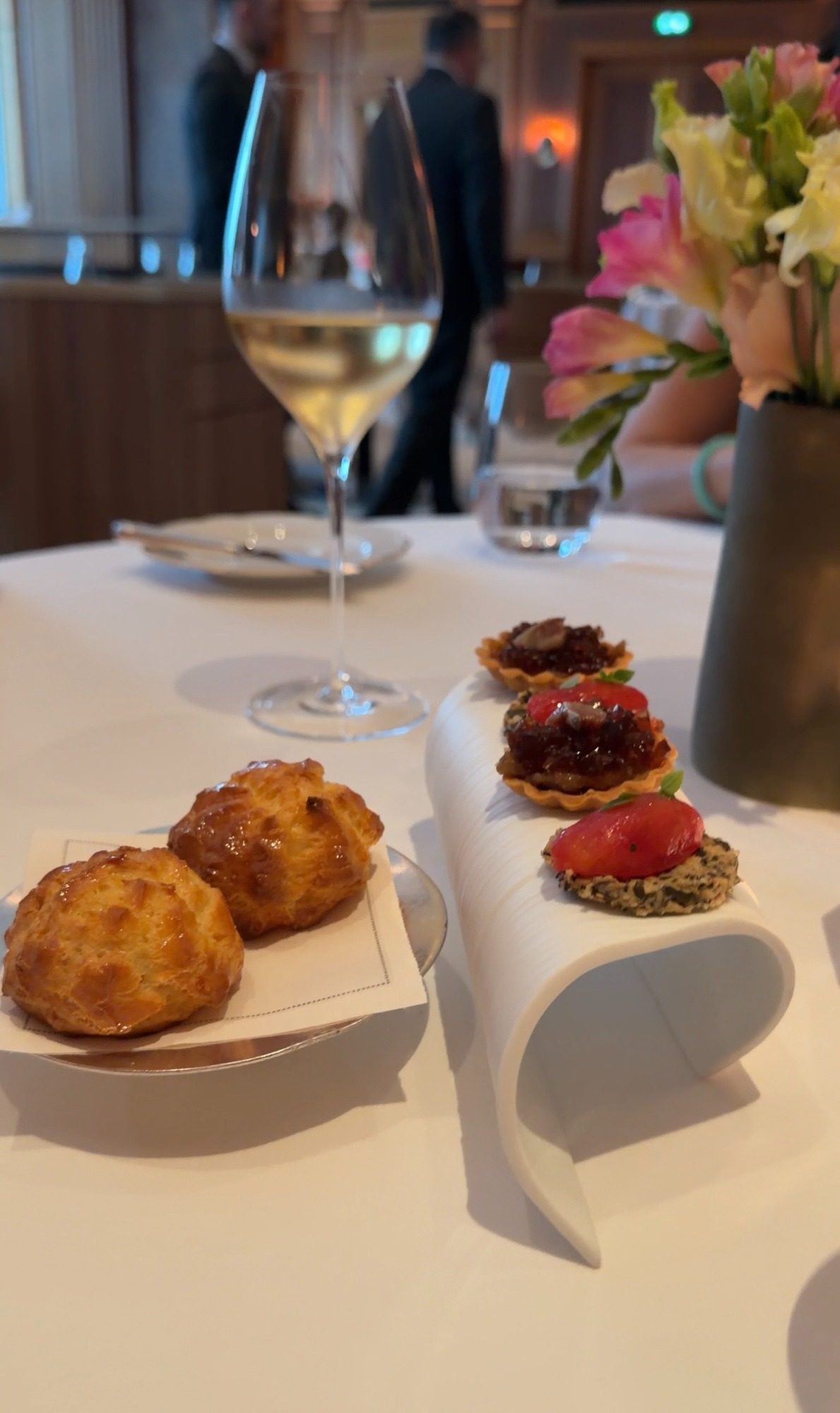 Cheese gougères and three savory tartlets with white wine at Le Taillevent in Paris