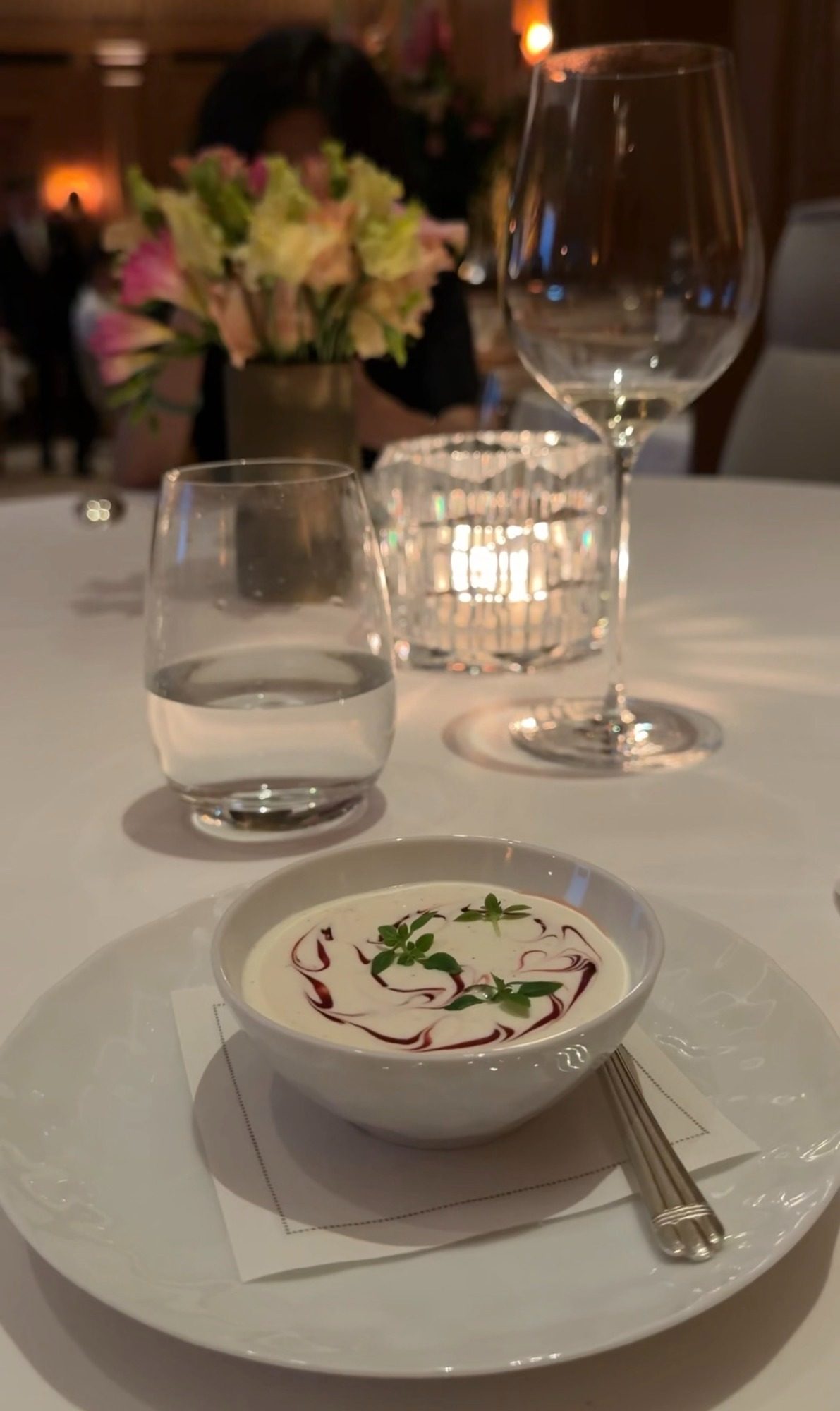White soup with a red swirl and herbs at Le Taillevent