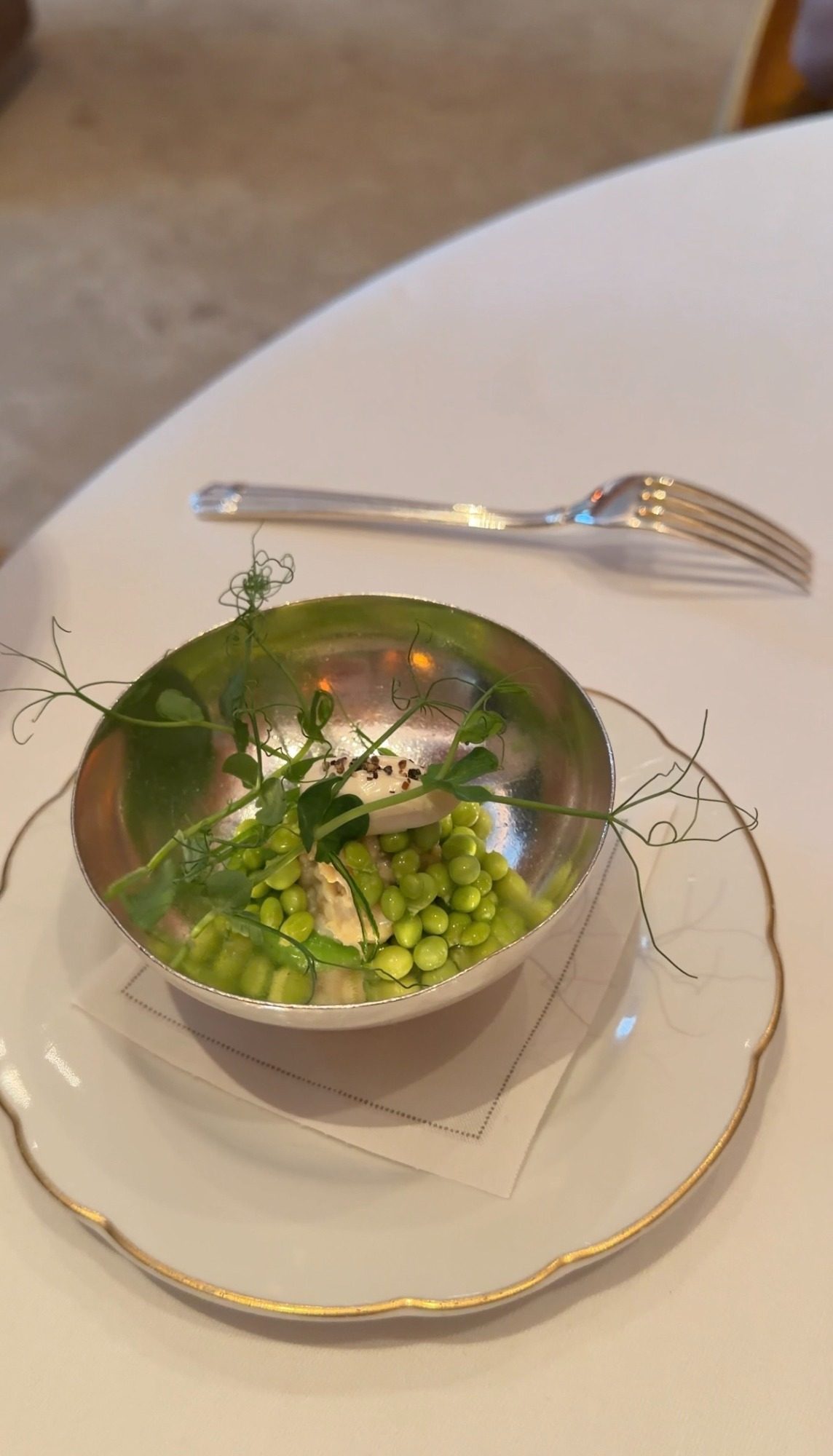 Spring peas and pea shoots in a silver bowl at Le Taillevent