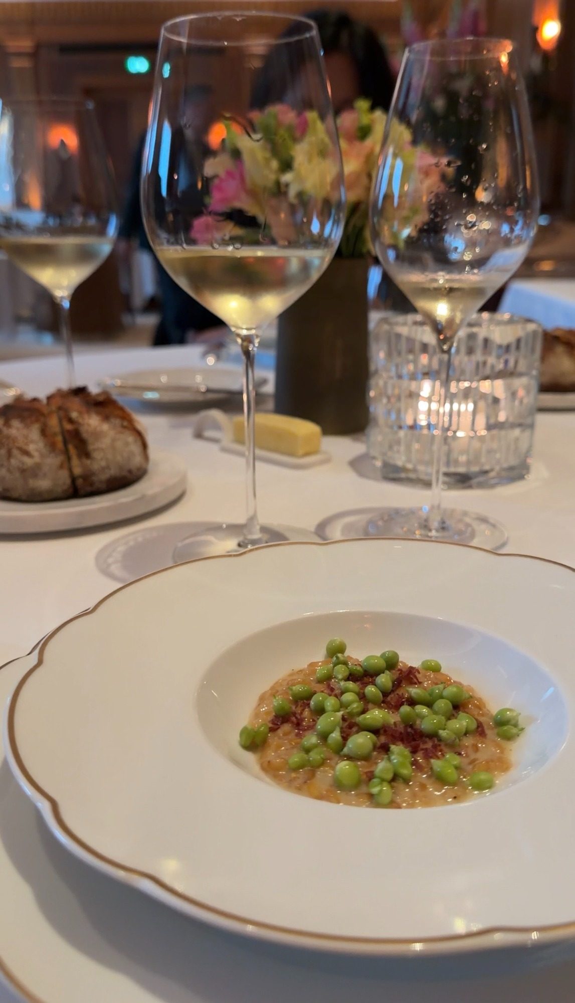 A plate of peas with white wine, bread, and butter at Le Taillevent