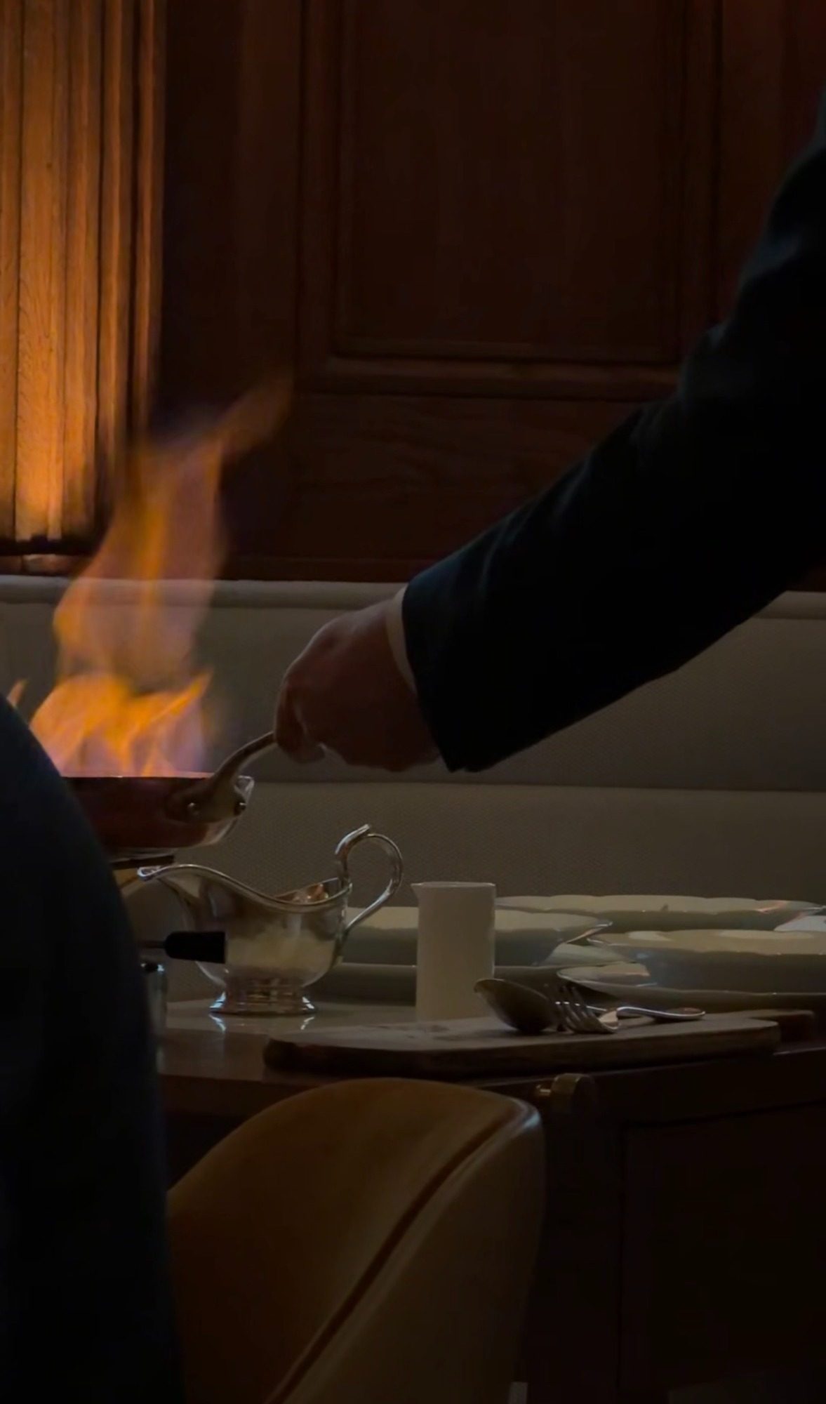 Tableside flambé at Le Taillevent, with a copper pan and a server in a dark suit