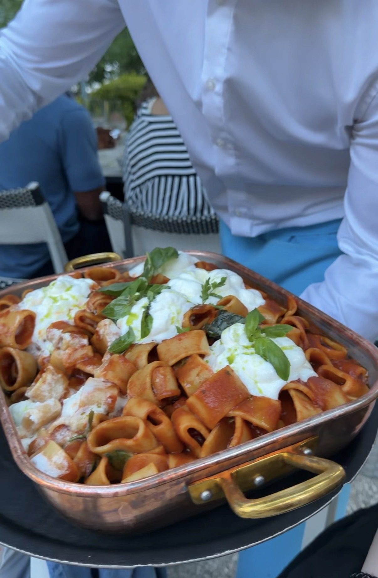 Wide pasta with tomato, mozzarella, and basil served outdoors in Locarno