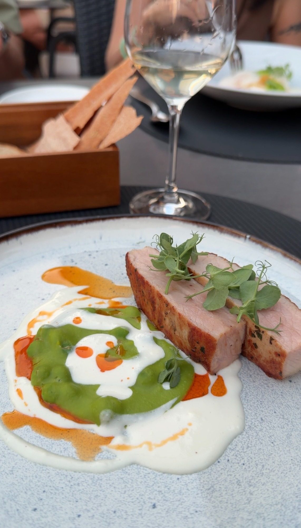 Pork with green sauce and white wine at dinner in Locarno