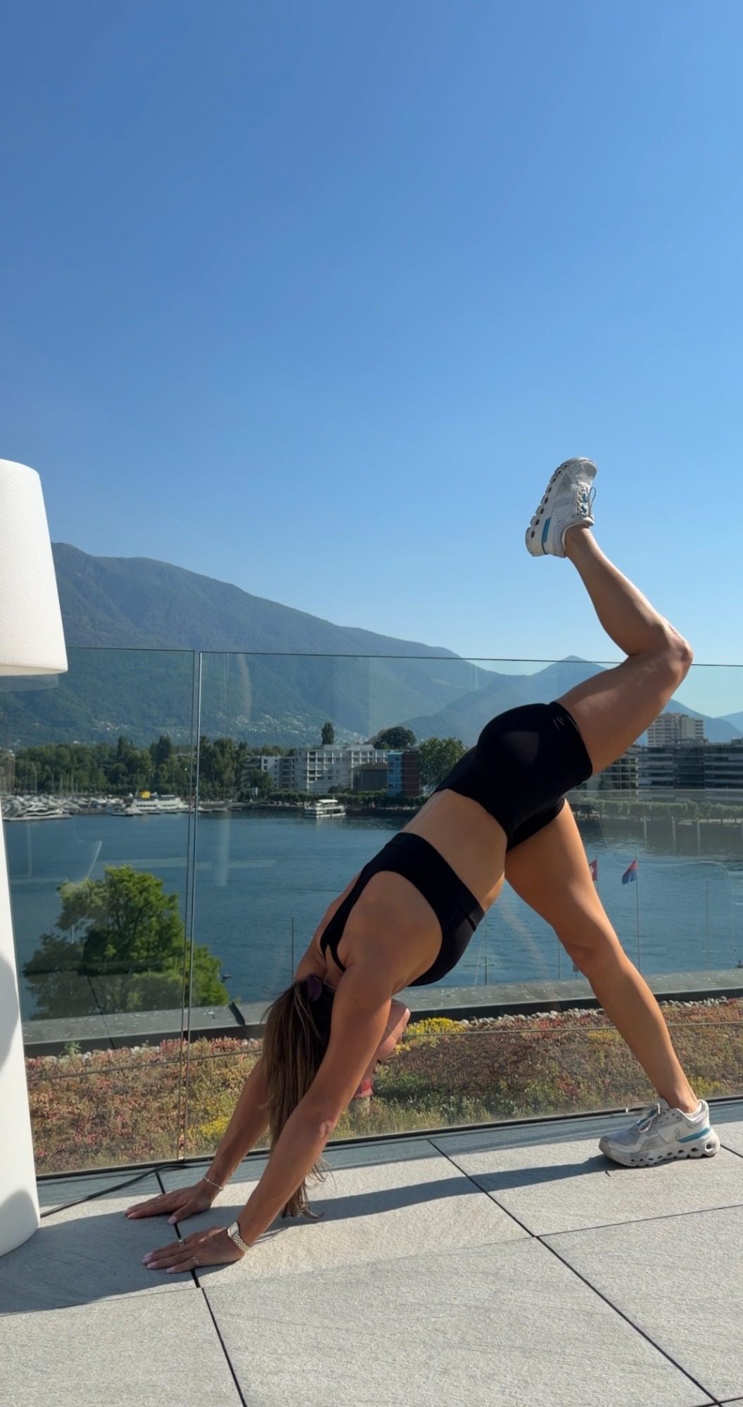 A morning stretch on a rooftop above the Locarno marina and Lake Maggiore