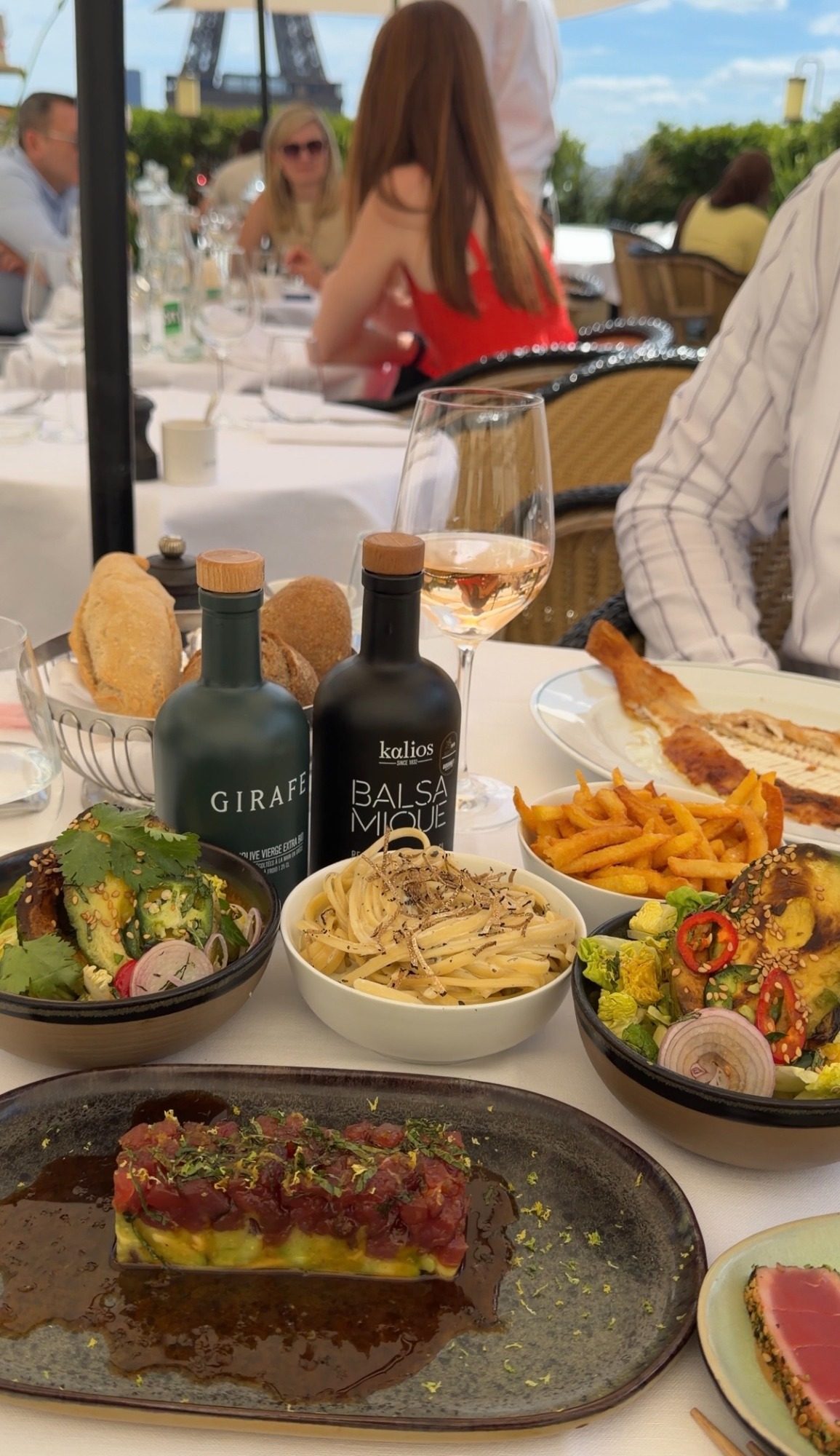 Paris lunch of tuna, fries, and grilled fish with the Eiffel Tower in the background